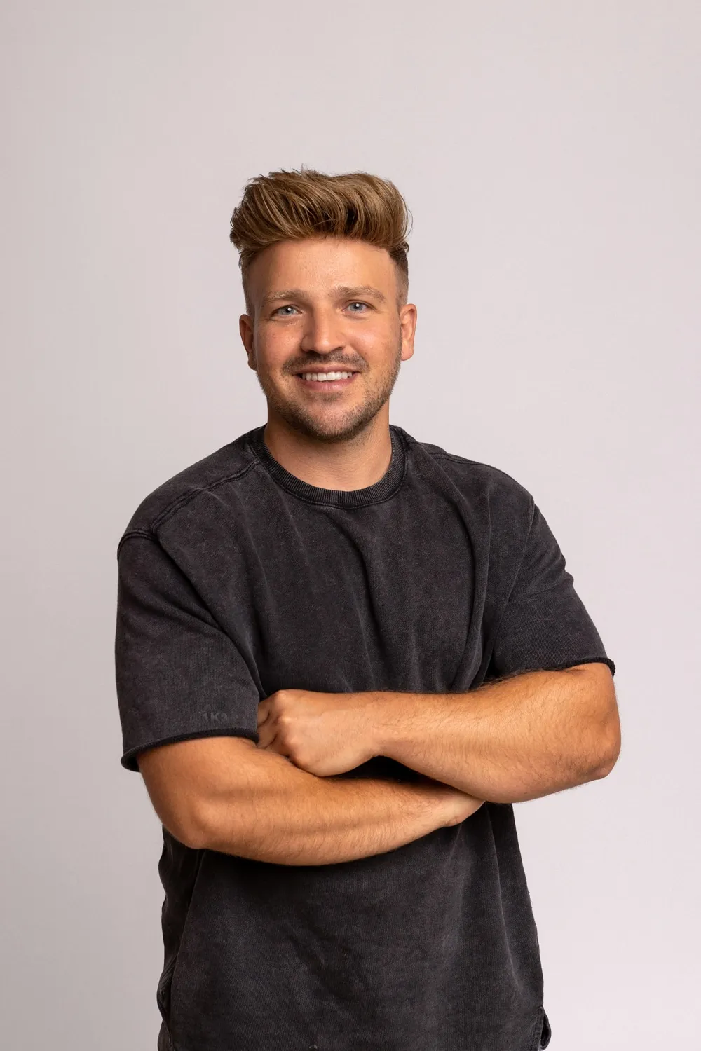 Hairify Kunde Marvin mit Haarsystem, lachend im schwarzen Shirt